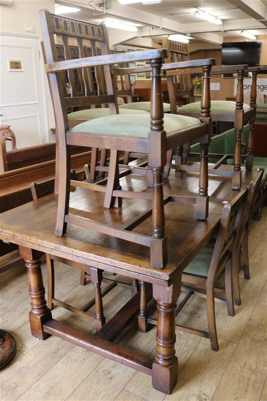 A draw leaf oak table and six chairs, W.168cm